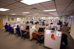 Image showing several Braille Works employees transcribing documents into braille and audio formats.