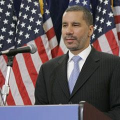 David Paterson standing behind a podium and microphone David Paterson standing behind a podium and microphone