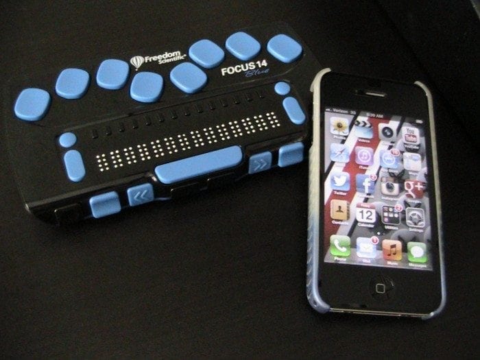 Image showing an iPhone and the Focus 14 braille display by Freedom Scientific