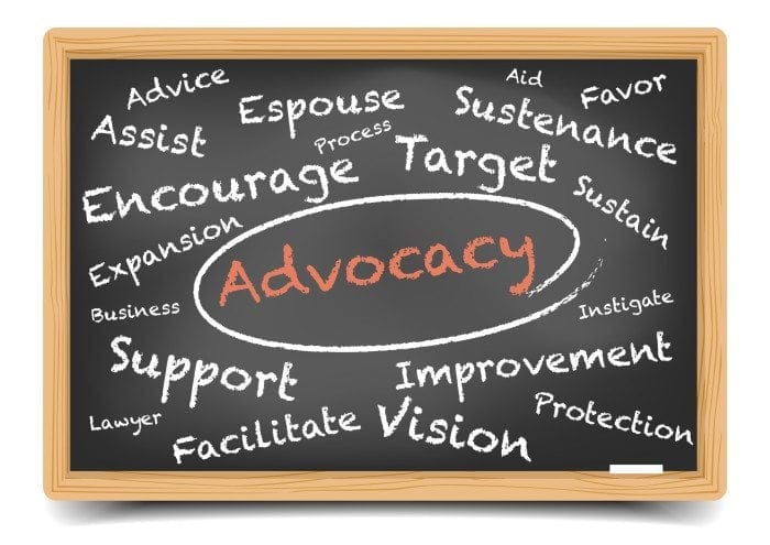 Image of a black chalkboard with advocacy-related words written in white and orange chalk. Image of a black chalkboard with advocacy-related words written in white and orange chalk.