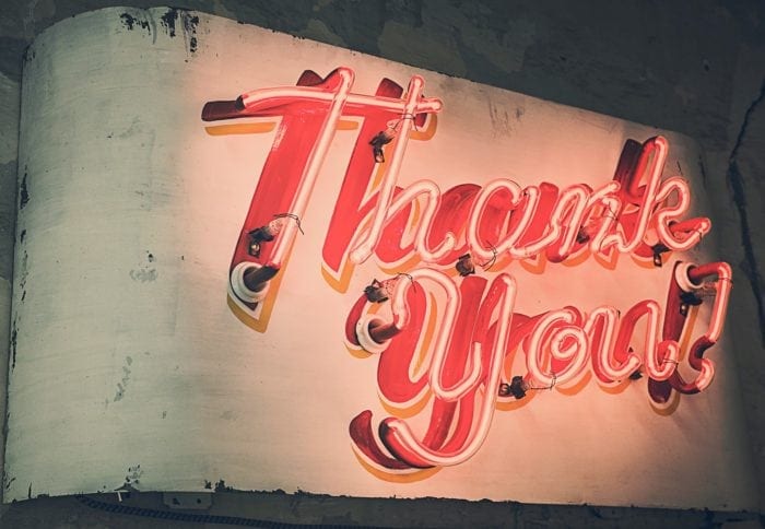 Red neon sign displaying the words "Thank You"