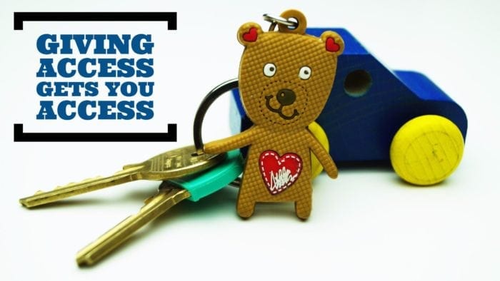 Key chain with a small plastic bear attached. The phrase "giving access gets you access" is displayed in text. Key chain with a small plastic bear attached. The phrase "giving access gets you access" is displayed in text.