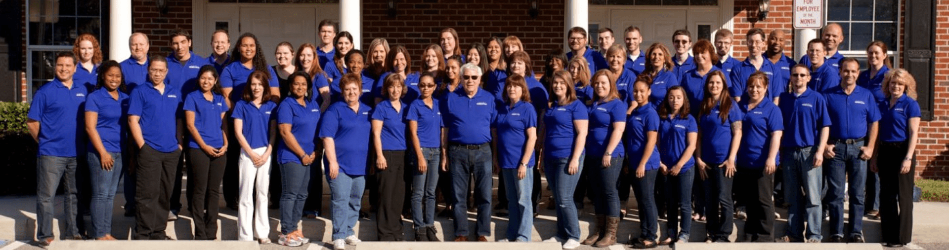 Image of the Braille Works staff standing together in front of the office.