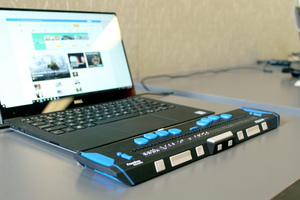 Open laptop with refreshable braille display